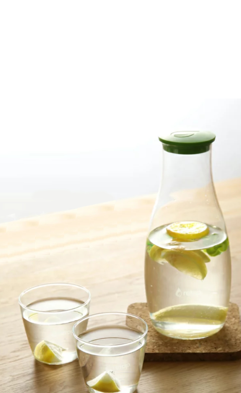 clear glass bottle with green liquid